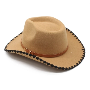 Detail of khaki felt cowboy hat featuring black whipstitch edges and brown leather band