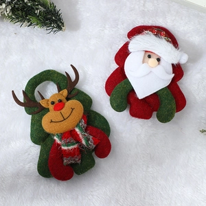 Plush Christmas tree ornaments set with Santa and reindeer on white faux fur background