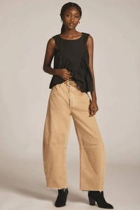 Sleeveless black crew neck top with V-shaped pleats and khaki wide leg raw hem jeans