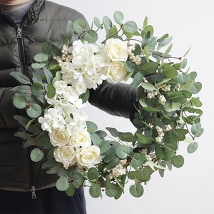 Handheld bridal wreath with white roses, hydrangea and eucalyptus for wedding decor