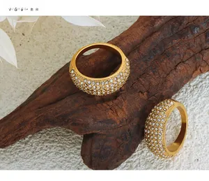 Detailed close-up of two gold titanium steel rings with star-like paved Czech diamonds