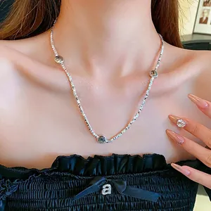 Silver square link necklace featuring three smiley face charms on a female model