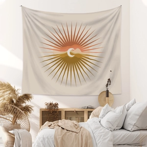 Detail of bohemian wall tapestry featuring abstract sun and moon motifs in warm desert tones