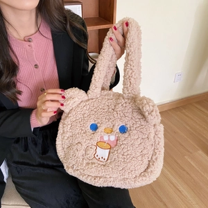 Detail of cute lamb wool handbag showing teddy bear embroidery drinking milk tea