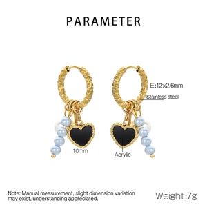 Detail of stainless steel hoop earring with black heart pendant and blue acrylic beads