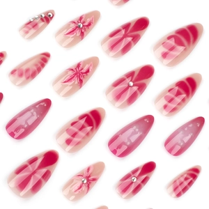 Faux ongles stiletto longs roses dégradés avec motifs floraux 3D et petits strass brillants
