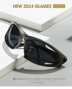 Close-up of dark grey Y2K sports sunglasses with computer safety lenses on white background