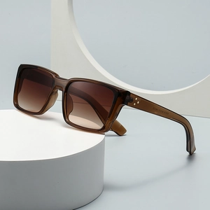 Modern rectangle sunglasses with brown frames and gradient lenses on a white display pedestal