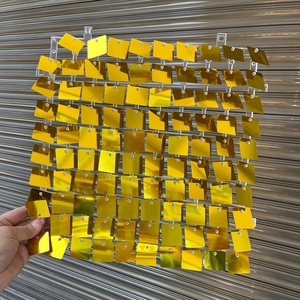 Detail of square gold sequin wall panel showing reflective shimmer for party backdrop décor