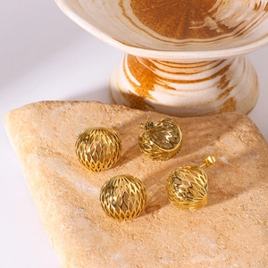 Golden stainless steel hollow mesh earrings set displayed on a natural stone surface