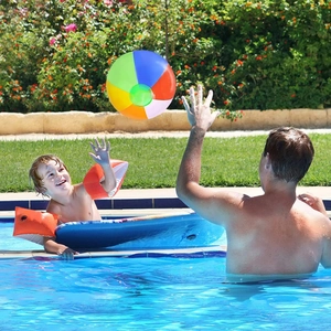 Inflatable orange arm floaties for kids used in a swimming pool during summer garden play