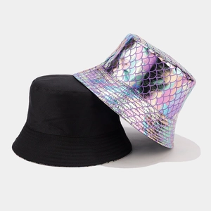 Detail of a reversible bucket hat showing the black fabric and colorful fish scale texture