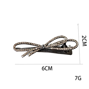 Detail of rhinestone bow hair clip with 6cm length and 2cm height measurements