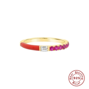 Macro detail of gold-plated 925 silver ring with red enamel and emerald-cut crystal