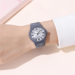 Detail of grey camouflage quartz watch with Arabic numerals shown worn on a wrist