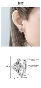Detail view of silver cross hoop earring with dimensions 1.28cm height and 1.45cm width