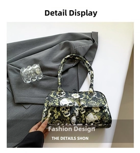 Detailed shot of skull and floral print handbag with dual front pockets on white desk