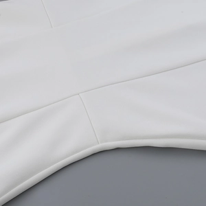 Macro shot of white mini dress fabric texture with high-quality seam and edge detail