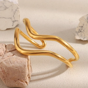 Close-up of double-layered wavy 18K gold plated stainless steel cuff on mineral stone
