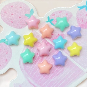 Colorful macaron star resin beads and DIY accessories displayed on a strawberry tray