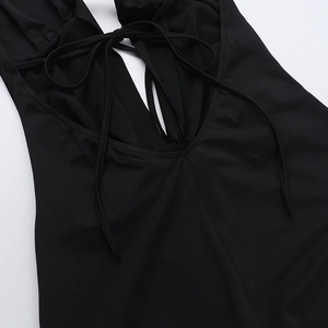 Close-up of lace-up neck details and fabric texture of a black deep V bodysuit