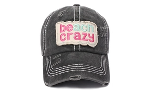 Detail of beach crazy pink embroidery on washed black distressed baseball cap