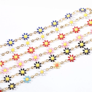 Detail of multi-colored daisy charms on gold plated stainless steel necklace chains