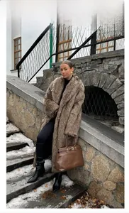 Detail of a thick brown faux fur long coat with a luxurious texture for winter warmth