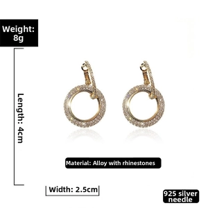 Macro view of geometric gold pavé circle earrings featuring 925 silver needles