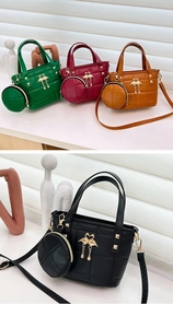 Detail of quilted leather bucket bag featuring gold swan logo and small round coin purse