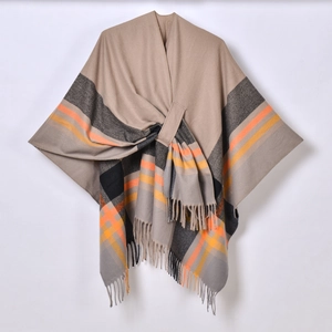 Detailed knit texture of beige plaid poncho with fringe trim and striped jacquard pattern
