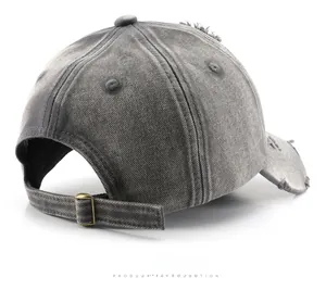 Detail of distressed brim and adjustable antique bronze metal buckle on the baseball cap
