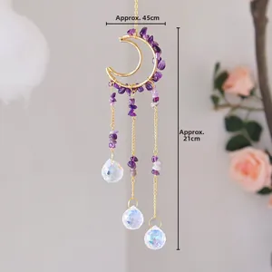 Detail of handmade moon suncatcher with purple amethyst stones and crystal ball hanging