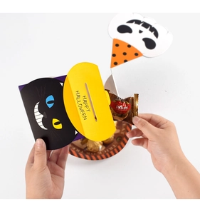 Macro detail of Halloween gift box showing candy bar inserted in paper cat card holder
