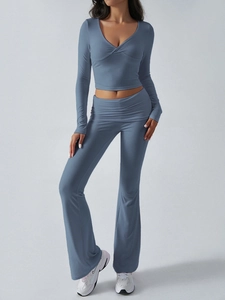 Detailed texture of grey-blue ribbed knit fabric on women's V-neck crop top and pants