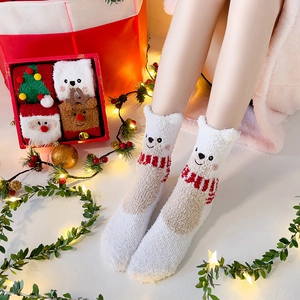 Cozy coral fleece Christmas socks featuring cute 3D bear designs for winter warmth.