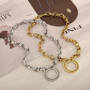 Detail of chunky link chain with a round Roman numeral pendant in gold and silver finish