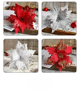 Macro shot of glittery artificial poinsettia flowers in red, silver, and gold for Christmas