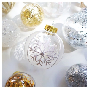 Detail of clear snowflake ornaments with gold and silver glitter Christmas tree balls