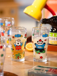 Close-up of two glass beer mugs featuring cute cartoon bear prints and fancy typography