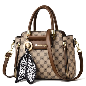 Classic checkered brown tote bag with leather handles and decorative leopard print scarf