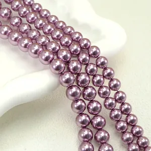 Macro detail of glossy purple round imitation pearls for DIY jewelry making and crafts