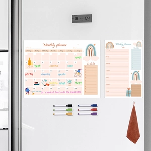 Detail view of magnetic rainbow monthly and weekly planner set with 6 markers on a fridge