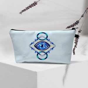 Detail of light blue Evil Eye makeup bag with geometric patterns and black zipper closure