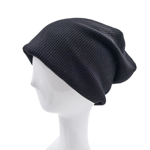 Black waffle knit beanie hat with slouchy design for outdoor warmth and street style