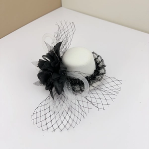 Elegant white fascinator hat with black flower, lace trim and mesh veil detail