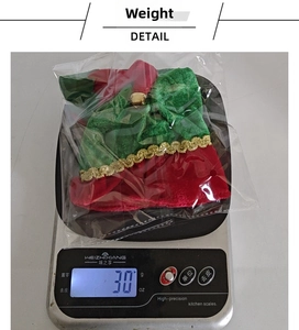 Weight measurement of festive Christmas wine bottle cover with bell and velvet texture