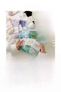 Detailed view of breathable mesh texture and rolled edge cuff on pastel cotton socks