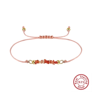 Detailed shot of pink natural stone handmade woven bracelet with 925 sterling silver charms