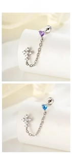 Detail of cross and heart zircon earrings with chain link for double piercings